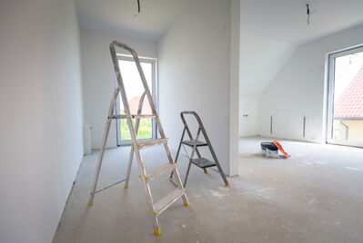 Two ladders in a bare room